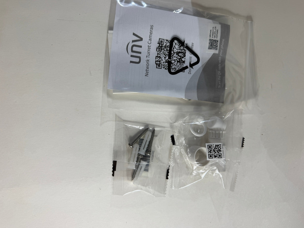 UNY Network Tunnel Cameras accessory kit in clear plastic packaging, containing screws, white plastic pieces, and a white instruction card with QR codes, on a white surface.