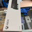 Xbox All Digital game box packaging photographed on a glass display table in a retail or office setting, with the Xbox logo and a controller graphic visible on the box.