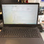 A Dell laptop with an Intel Core processor and Windows 11 Pro shown open on a desk, with a blurred office background.