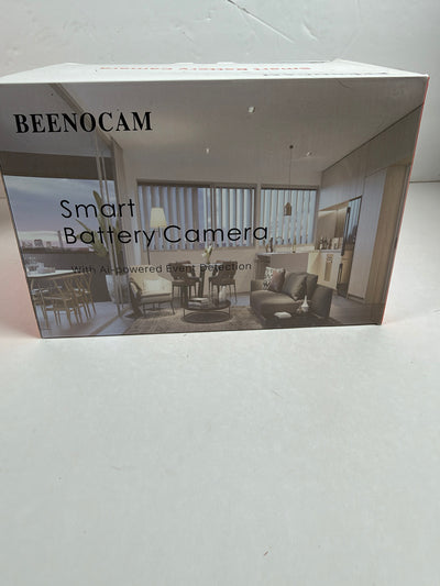 A boxed smart battery camera product labeled BEENOCAM, shown standing on a light surface. The front of the box features a grayscale interior room photo and the text 'Smart Battery Camera' and 'with AI-powered smart detection.