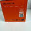 Orange Beenocam product packaging box showing the back side with model text, feature checkboxes, AI inside icon, and a QR code on a white surface.