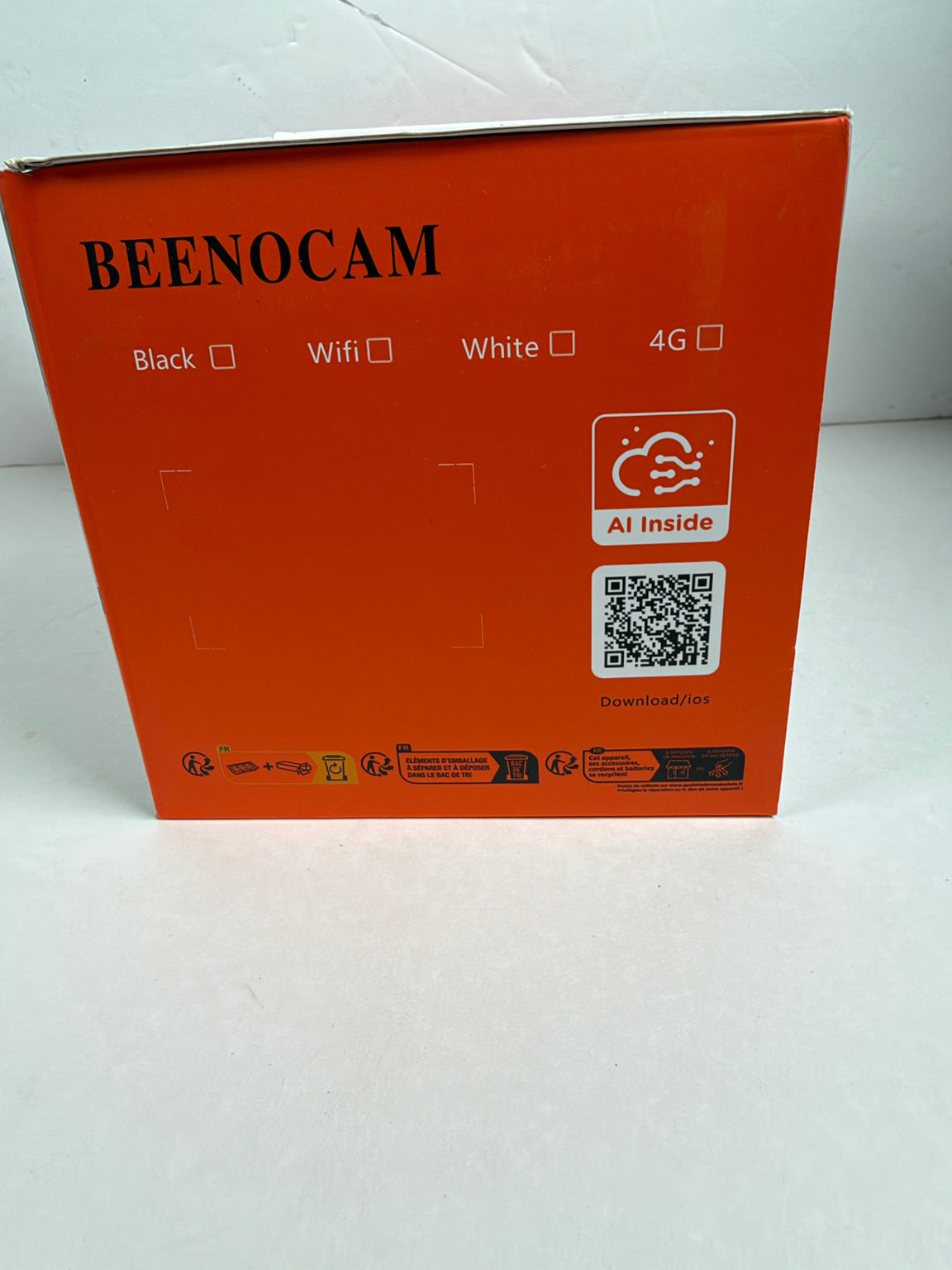 Orange Beenocam product packaging box showing the back side with model text, feature checkboxes, AI inside icon, and a QR code on a white surface.