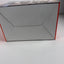 A cardboard product box photographed on a plain light surface, showing the inside bottom panel and side edges with a thin red outline.