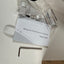Network fixed dome camera kit contents laid out on a white surface, including a quick guide booklet, mounting hardware in a clear plastic bag, and a metal hex key.