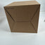 A plain brown cardboard box photographed on a white surface against a white wall. No person, animal, or real environment beyond the simple studio-like setup is present, so this is Product/Packaging.