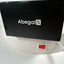 A close-up of a black rectangular device with the white AbegalS logo, mounted on a white circular base with a red power switch and a white tube connected to it.