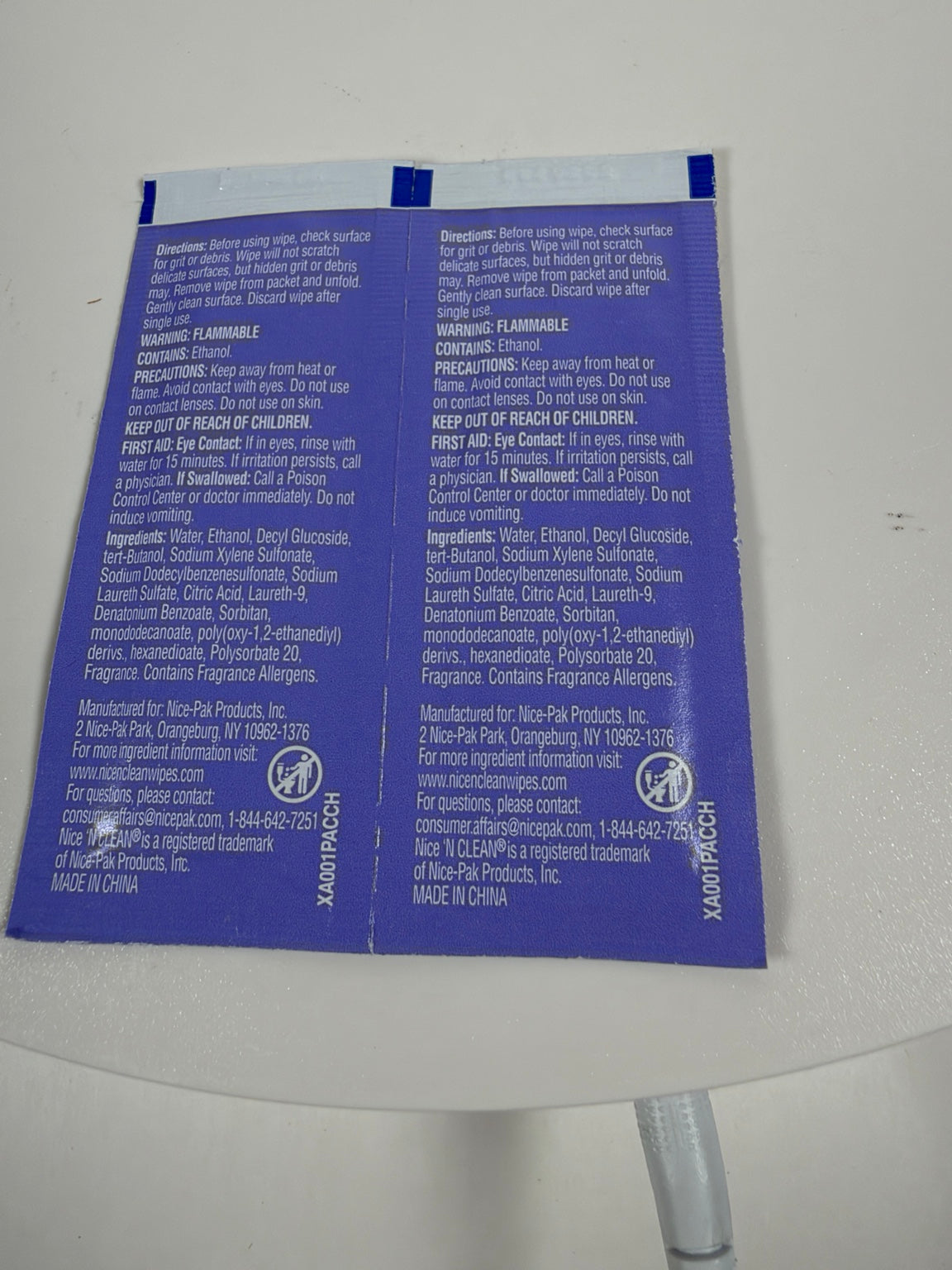 Two blue and white Nip+Pak chemical safety data sheets (SDS) for Flammable Liquid A and Flammable Liquid B, displayed side-by-side on a light-colored surface.