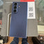 A blue Samsung Galaxy Z Fold smartphone is shown from the back, resting on its original gray packaging box. The box features the Samsung logo and 'Galaxy Z Fold' text.