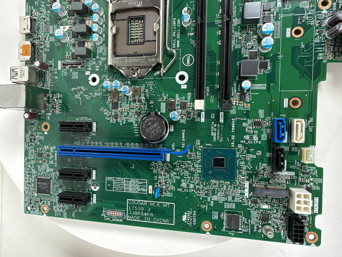 A green computer motherboard with an LGA1200 socket, RAM slots, a blue PCIe slot, and various electronic components, photographed from above on a white background.