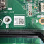 Close-up of a green printed circuit board with visible components, a white QR code label, and printed text including CPU, REV:A00, APS-PETS, and FAN.