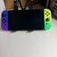 Nintendo Switch OLED Splatoon 3 Special Edition front view with purple and neon green Joy-Con controllers