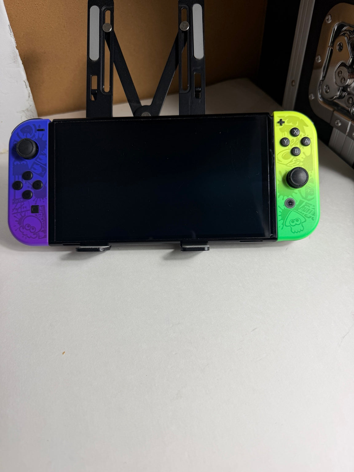 Nintendo Switch OLED Splatoon 3 Special Edition front view with purple and neon green Joy-Con controllers