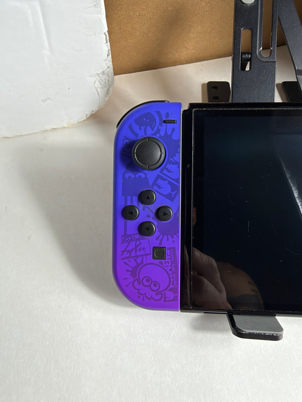 Nintendo Switch OLED Splatoon 3 Special Edition front view with purple and neon green Joy-Con controllers