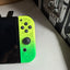 Close-up of neon yellow and green Splatoon 3 Nintendo Switch OLED right Joy-Con