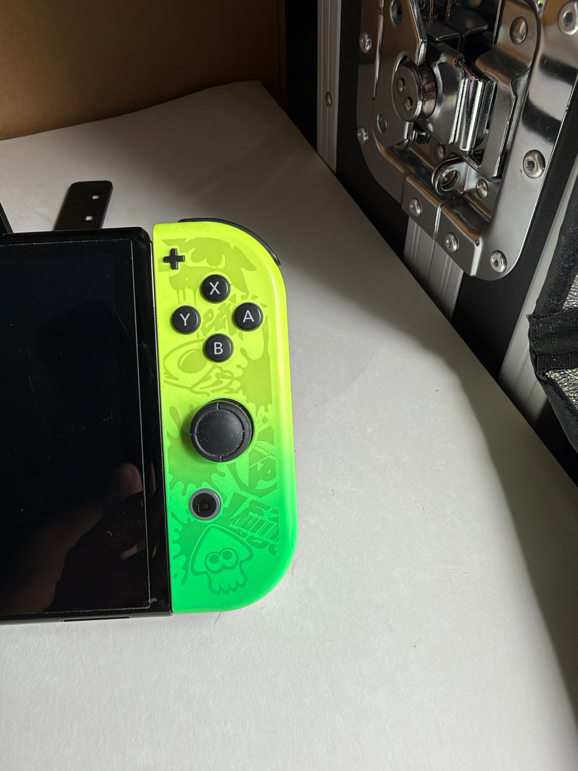 Close-up of neon yellow and green Splatoon 3 Nintendo Switch OLED right Joy-Con