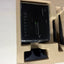 An Amed Wireless router in its original beige cardboard packaging insert, alongside two black antennas and a black accessory piece.