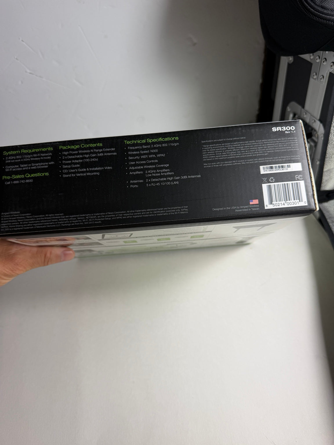 Amped Wireless SR300 High Power Wireless-N Range Extender retail box showing 2.4GHz frequency, 300Mbps speed and five Ethernet ports.