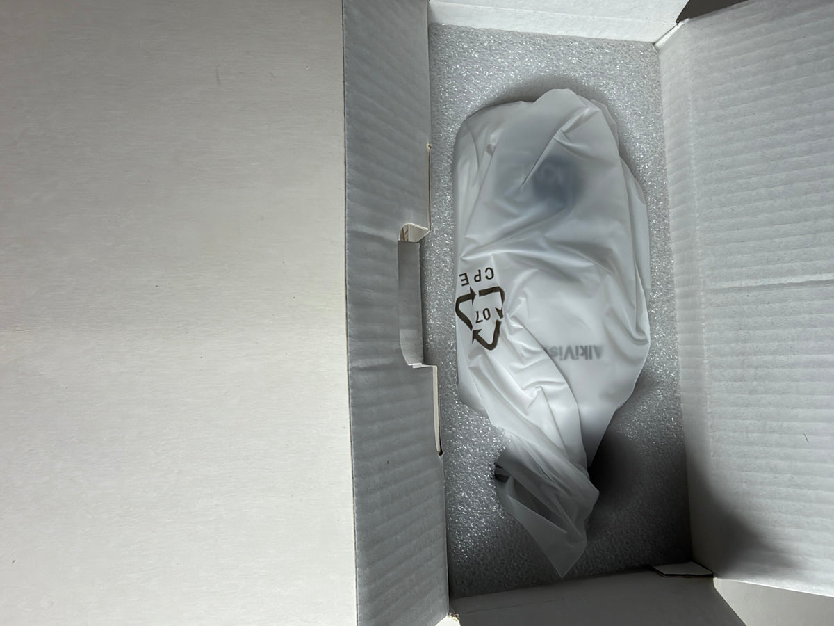 A white protective plastic bag with a black recycling symbol and partial 'AIR.