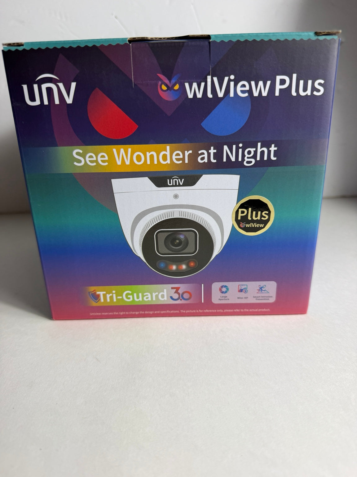 Uniview Plus security camera retail box on a light gray surface, featuring a colorful gradient design with a printed image of a dome security camera.