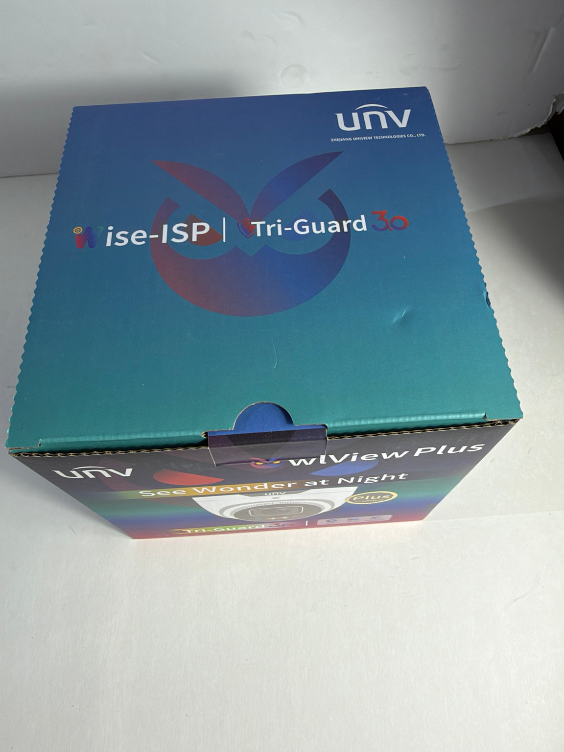 UNV WiView Plus 1080p IP camera retail box on a white surface, showing blue and teal packaging with product branding and a small camera photo on the front.