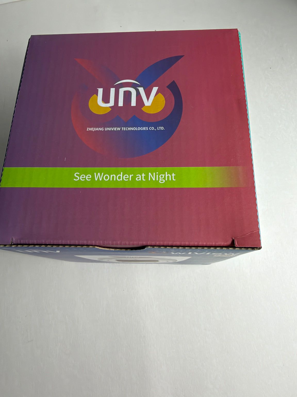A square product box for UNV LED light therapy, featuring a purple-to-pink gradient design with a green band reading 'See Wonder at Night' and the UNV logo.
