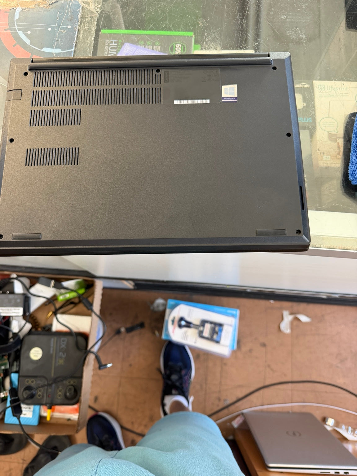 Lenovo ThinkPad E14 laptop bottom panel with cooling vents and Windows sticker