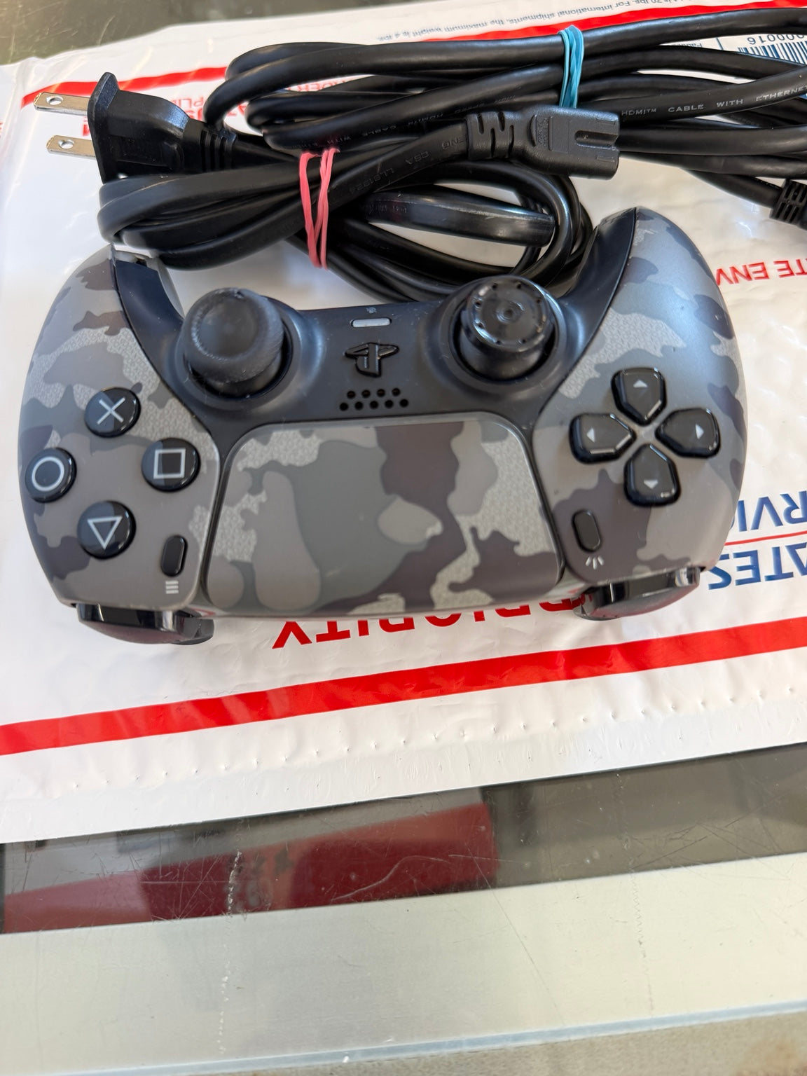 Sony PlayStation 5 DualSense gray camouflage wireless controller front view with buttons and thumbsticks