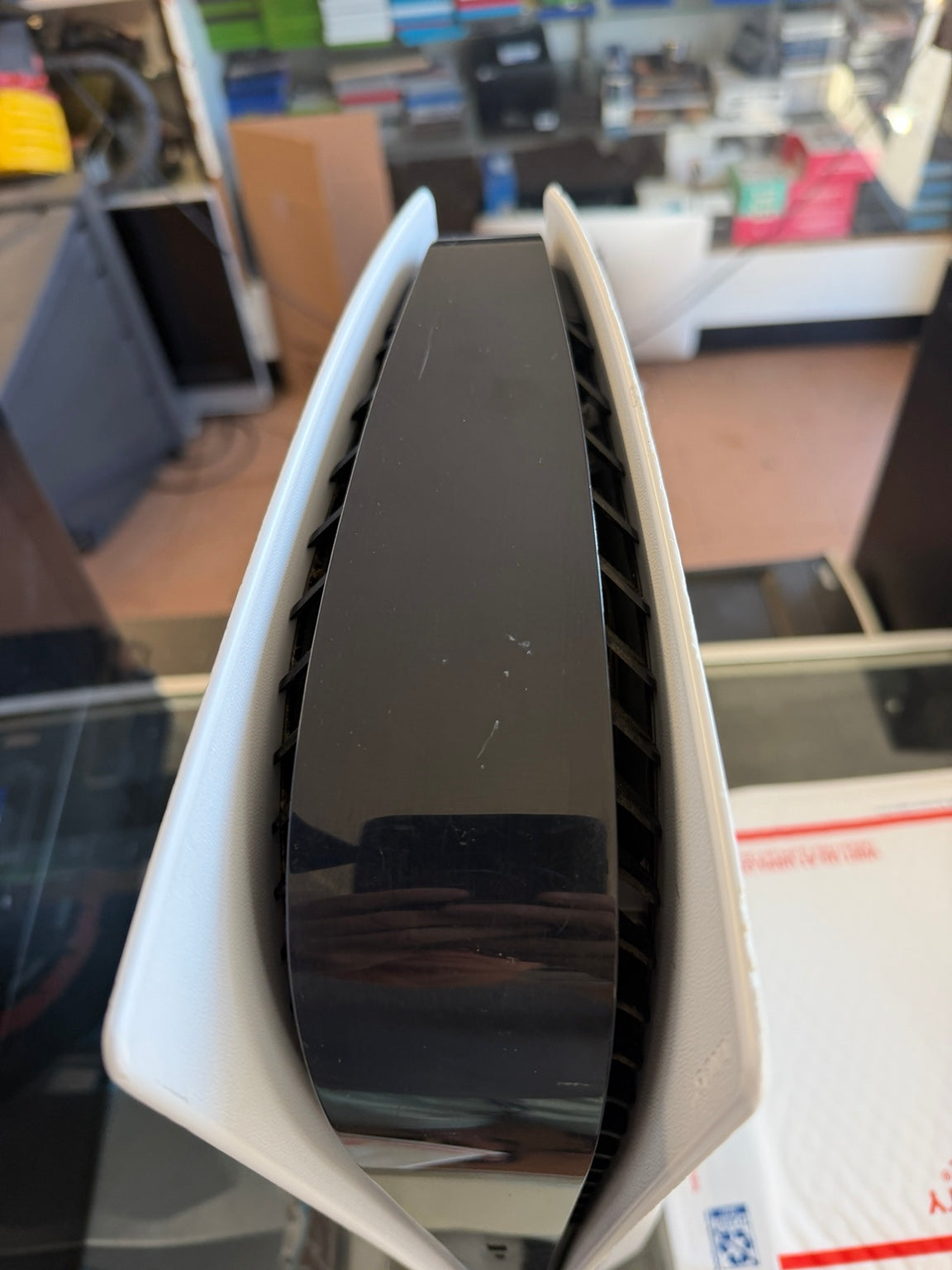 Sony PS5 Disc Edition top view showing glossy black center panel and ventilation
