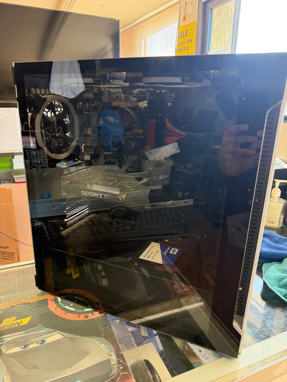 Custom gaming PC tempered glass side panel showing internal components