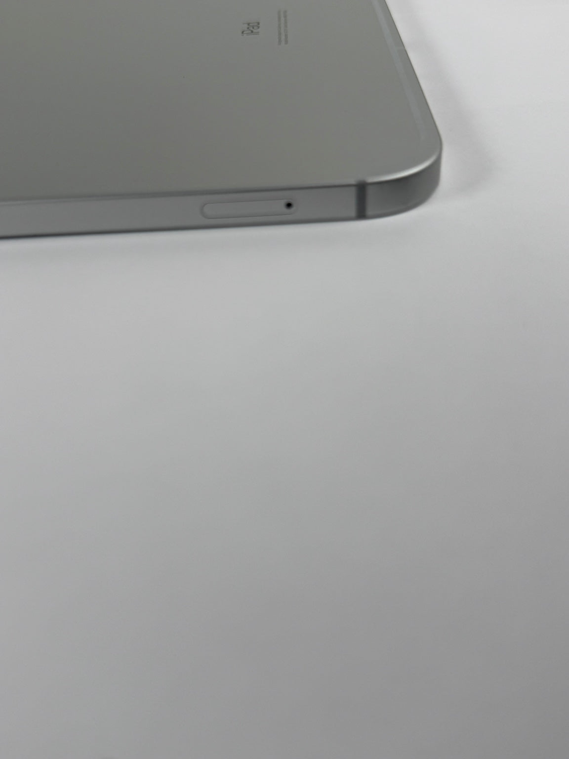 Apple iPad 10th Gen Wi-Fi Cellular Silver SIM card tray side view