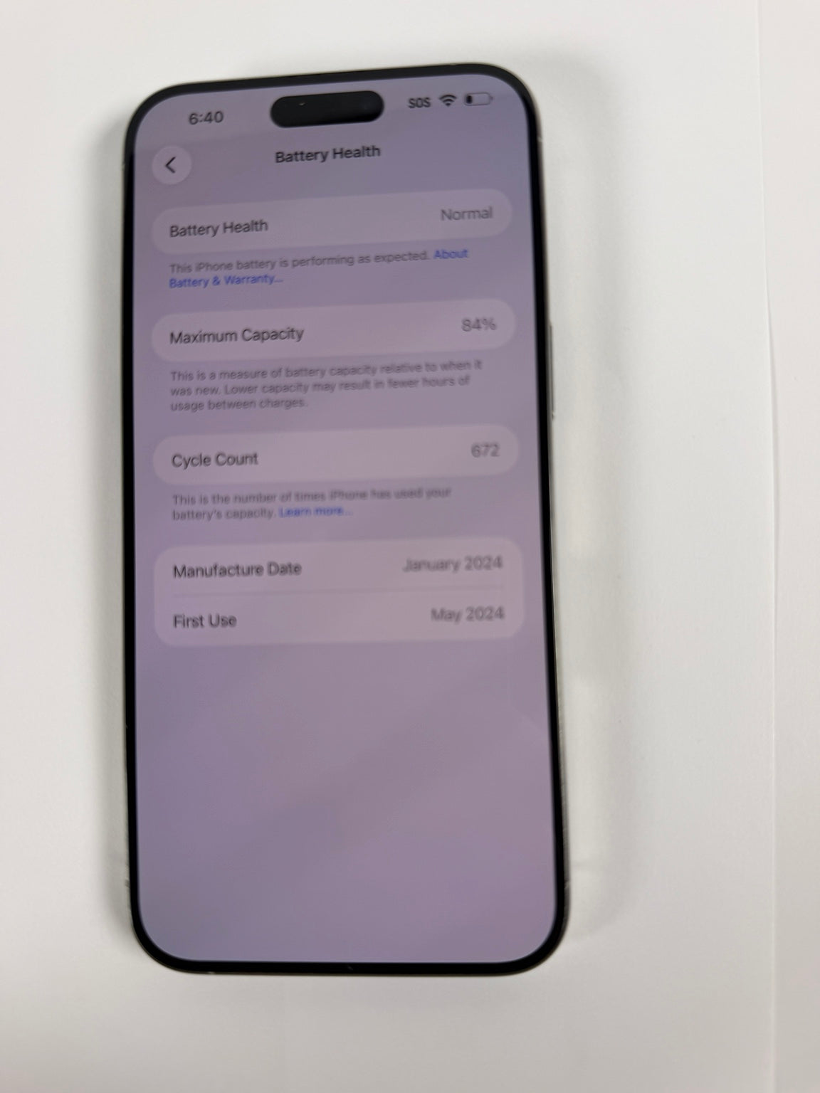 Apple iPhone 15 Pro Max showing 84 percent battery health and 672 cycles