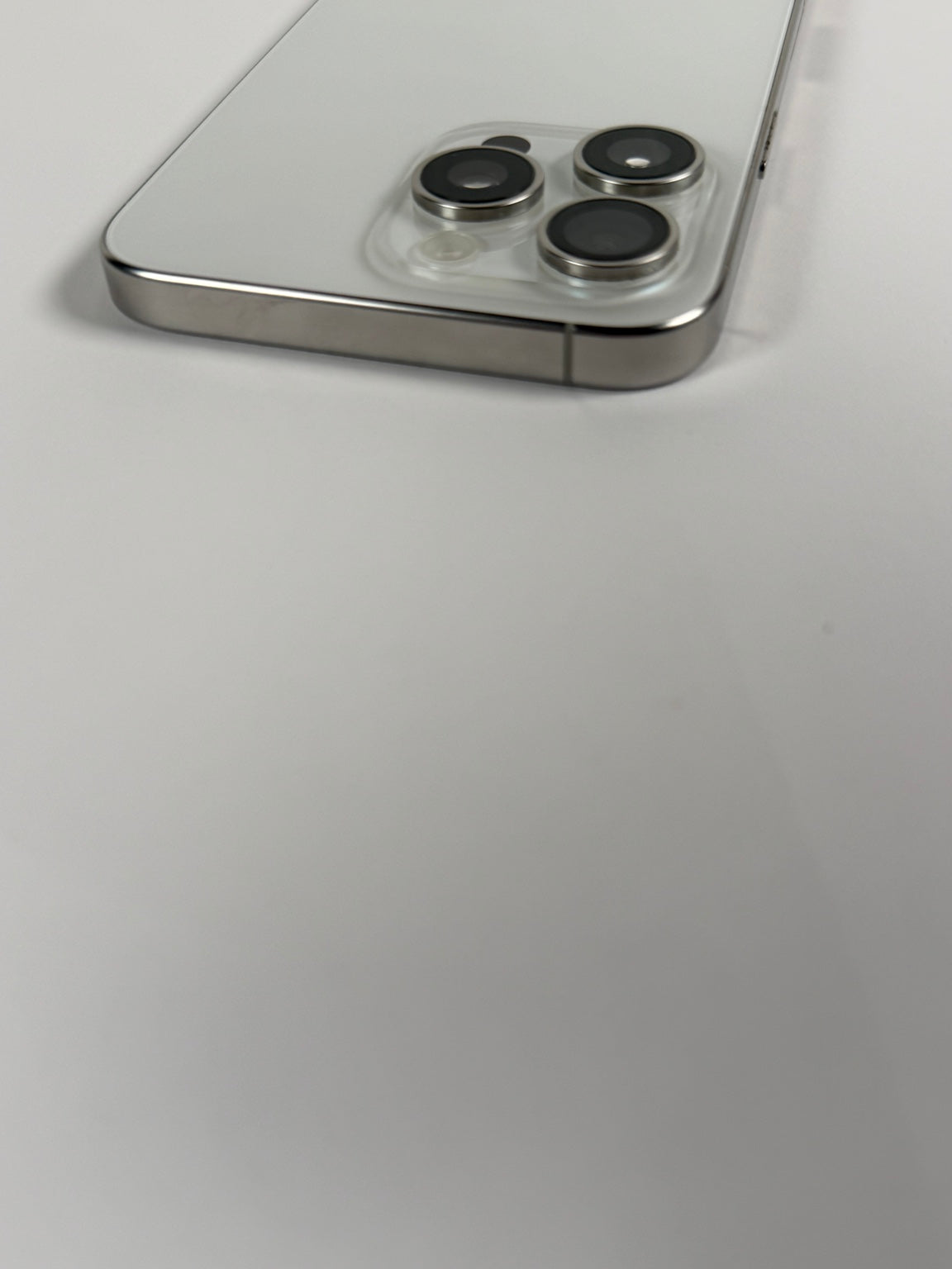 Apple iPhone 15 Pro Max Natural Titanium triple rear camera close-up