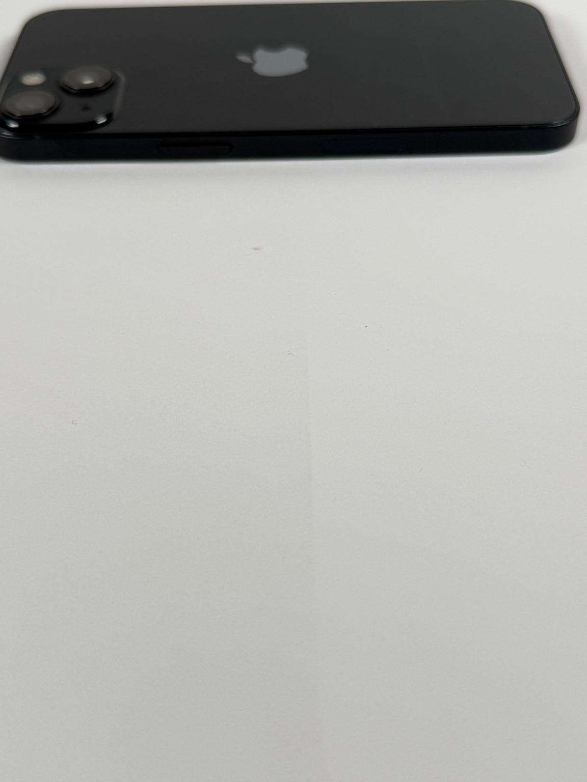 Apple iPhone 13 side view showing volume buttons and mute switch