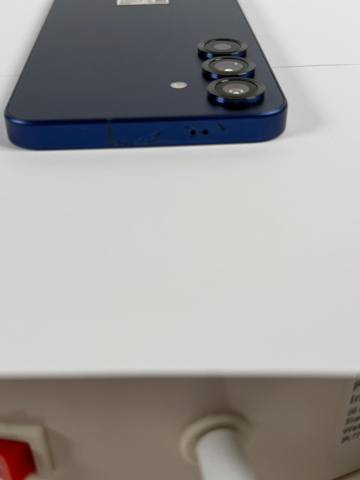 Samsung Galaxy S25 top edge close-up showing cosmetic wear