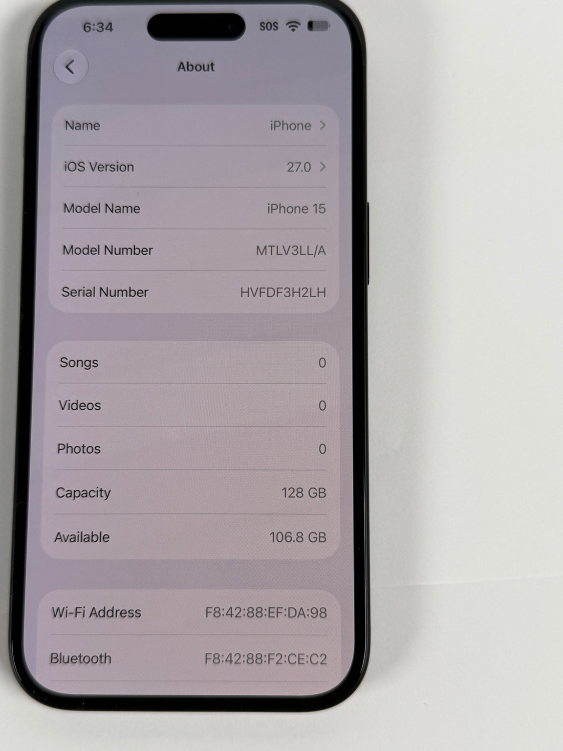 Apple iPhone 15 Settings showing 128GB storage and model information