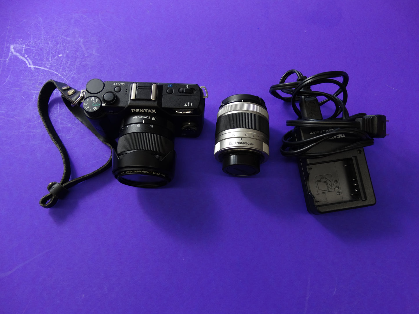 Pentax Q7 Mirrorless Camera Kit – Body + 2 Lenses (Pentax 02 Standard Zoom) + Charger & Strap