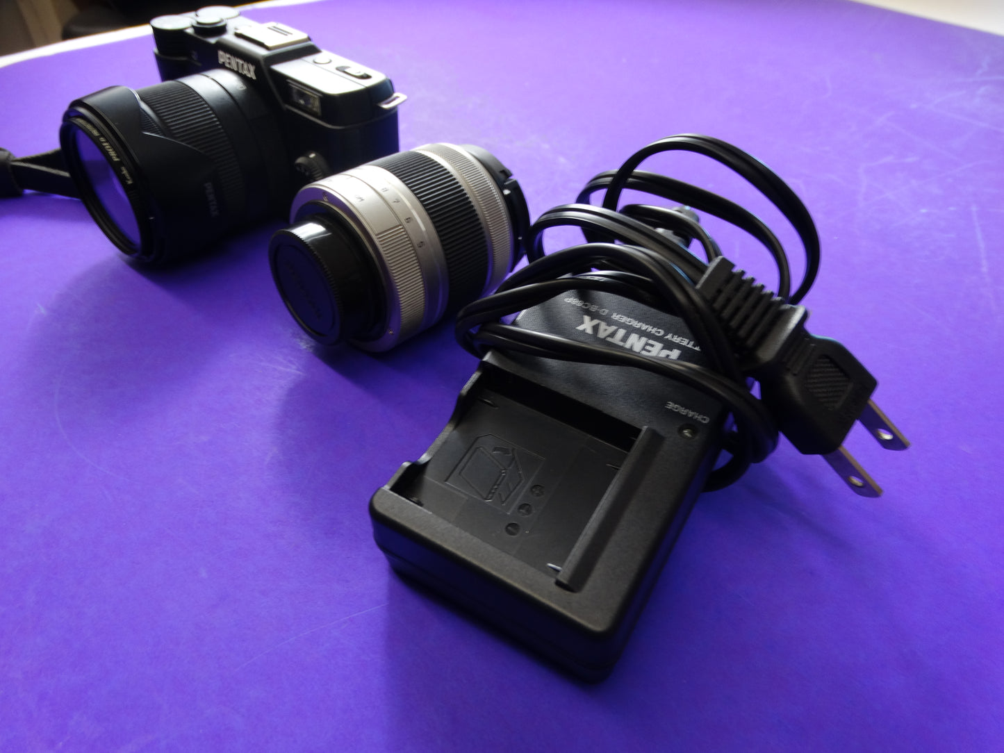 Pentax Q7 Mirrorless Camera Kit – Body + 2 Lenses (Pentax 02 Standard Zoom) + Charger & Strap