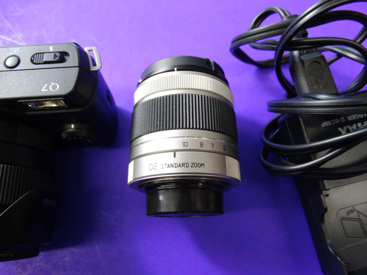 Pentax Q7 Mirrorless Camera Kit – Body + 2 Lenses (Pentax 02 Standard Zoom) + Charger & Strap